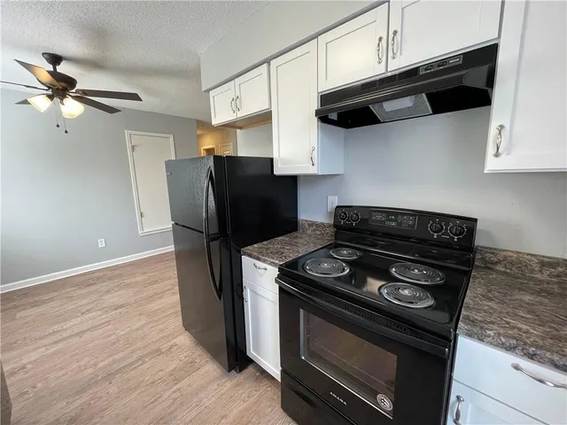 a kitchen with stainless steel appliances granite countertop a stove and a refrigerator