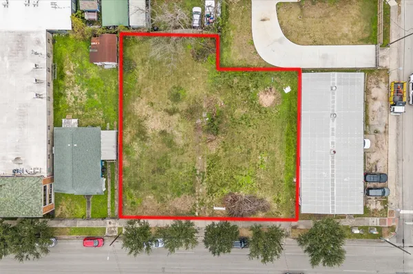 aerial view of a house with a yard and potted plants