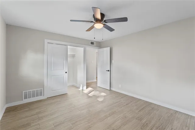 a view of an empty room and wooden floor
