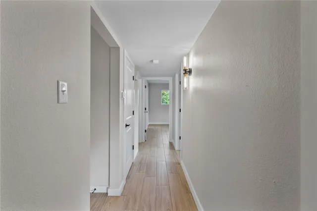 a view of a hallway with wooden floor