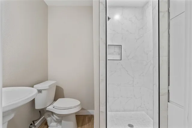 a white toilet sitting next to a bathroom sink