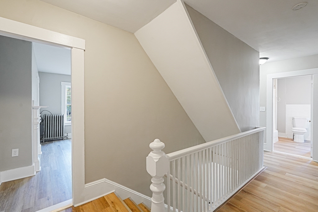 72 Main Street Pepperell, MA 01463 - Photo 9 of 26 a view of a hallway with wooden floor and staircase