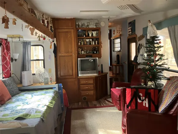 a bedroom with furniture and a window