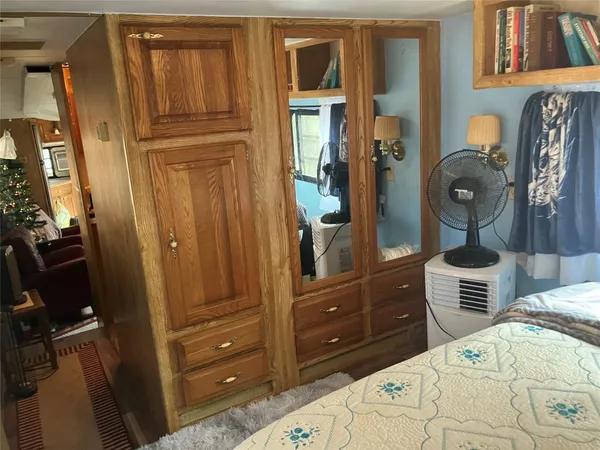 a bedroom with a bed and dresser