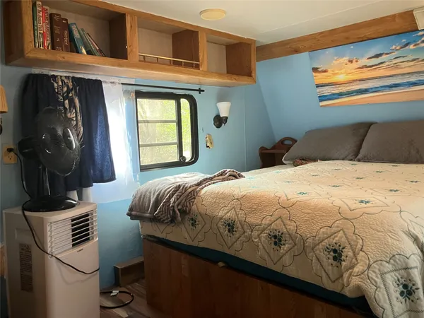 a bed with white sheets and pillows on it