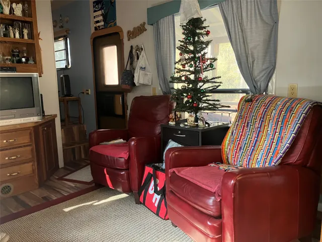 a room with furniture bookshelf and a window