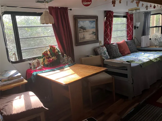 a bedroom with furniture and a window