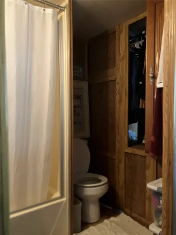 a bathroom with a toilet and a shower