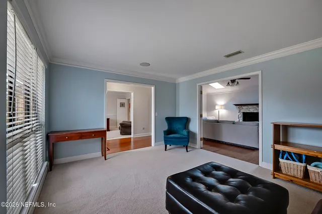 a living room with furniture and a piano