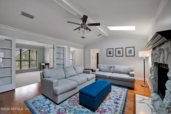 a living room with furniture a fireplace and a flat screen tv