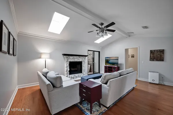 a living room with furniture and a fireplace