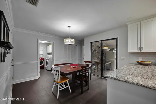 a kitchen with a table and chairs in it