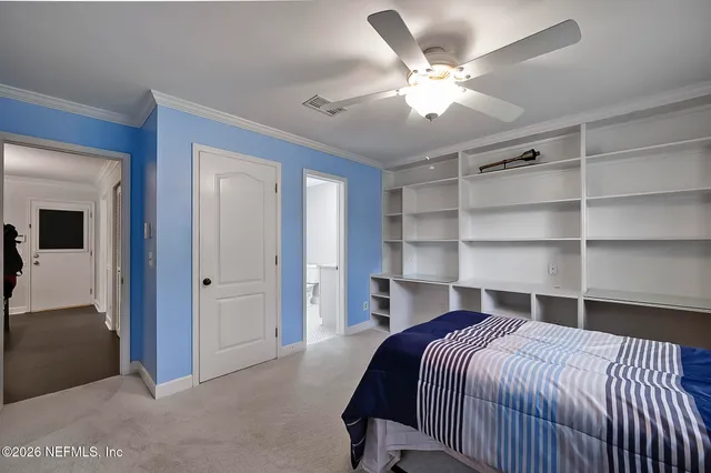 a bed room with a bed and a ceiling fan