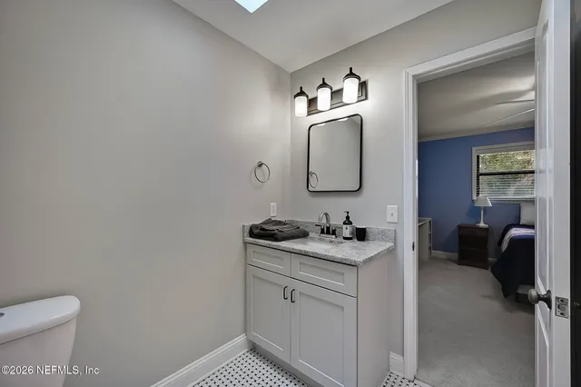 a en suite bathroom with a toilet sink and mirror