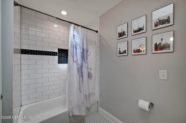 a bathroom with a shower and a shower