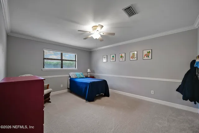 a bedroom with furniture and a window