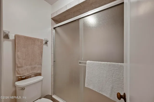 a bathroom with a shower and a toilet