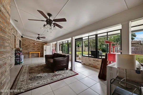 a living room with furniture and a floor to ceiling window
