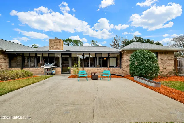 a view of a house with swimming pool and a yard