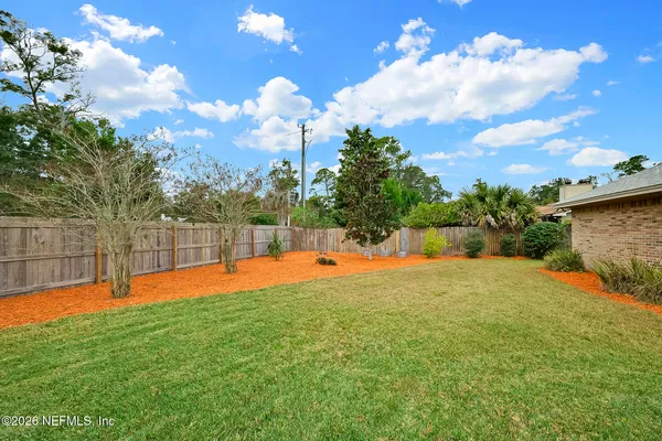 a view of a backyard with swimming pool