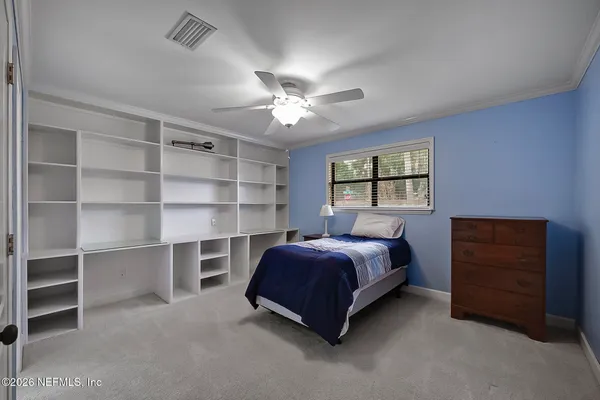 a bed room with a bed and a window