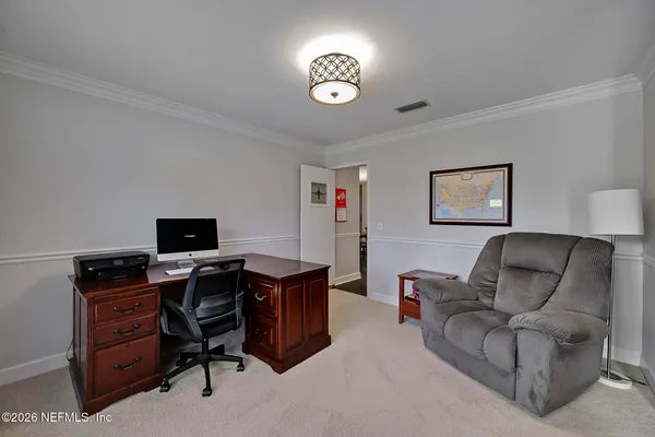 a view of a livingroom with workspace and a couch