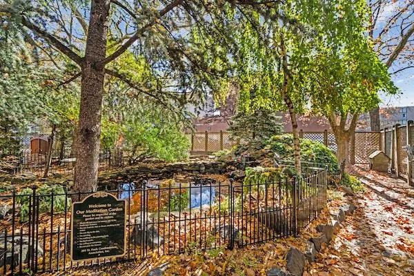 a view of house with wooden deck and trees