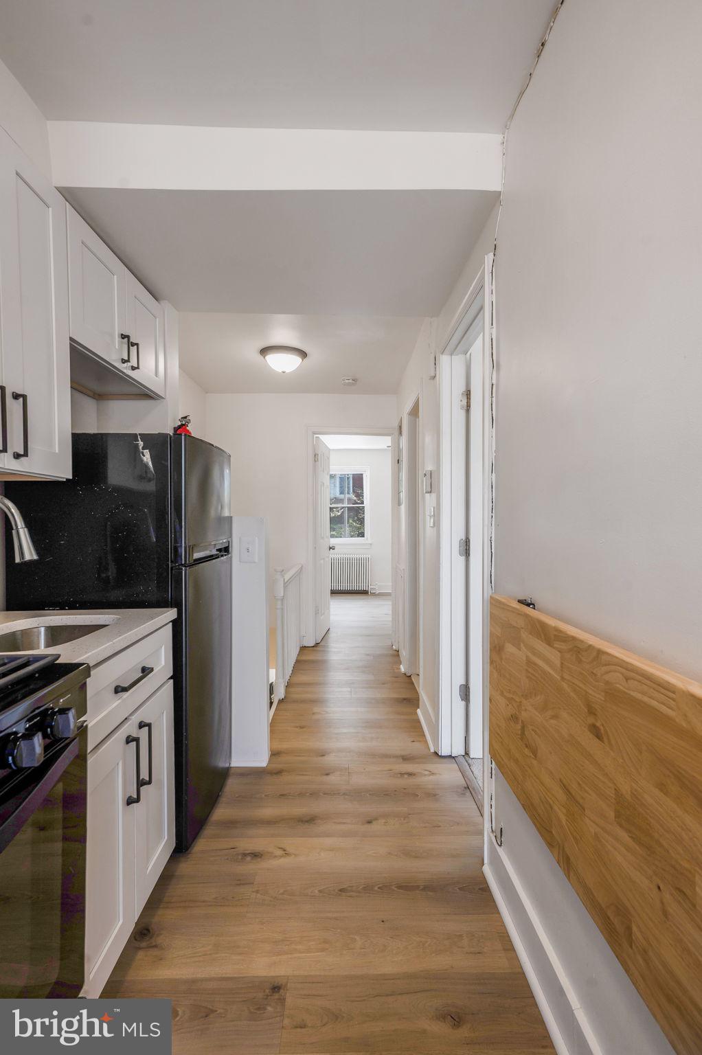 2538 9th Street Northwest, Unit B Washington, DC 20001 - Photo 11 of 19 a view of a kitchen with wooden floor and electronic appliances
