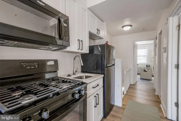 a kitchen with a stove microwave and a sink