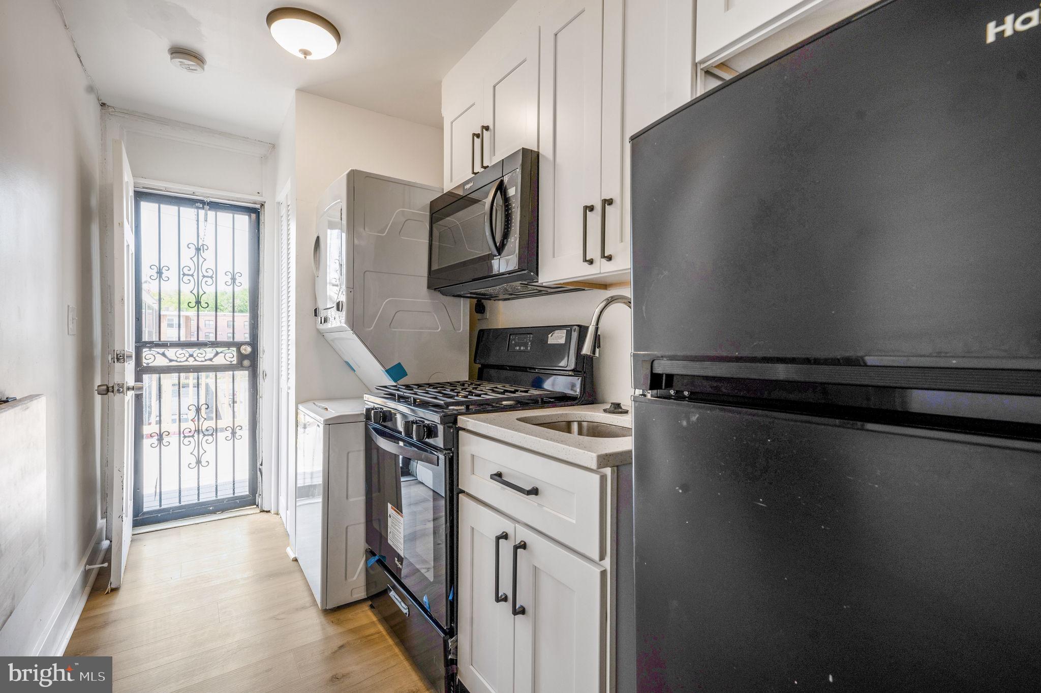2538 9th Street Northwest, Unit B Washington, DC 20001 - Photo 13 of 19 a kitchen with a stove microwave and a sink