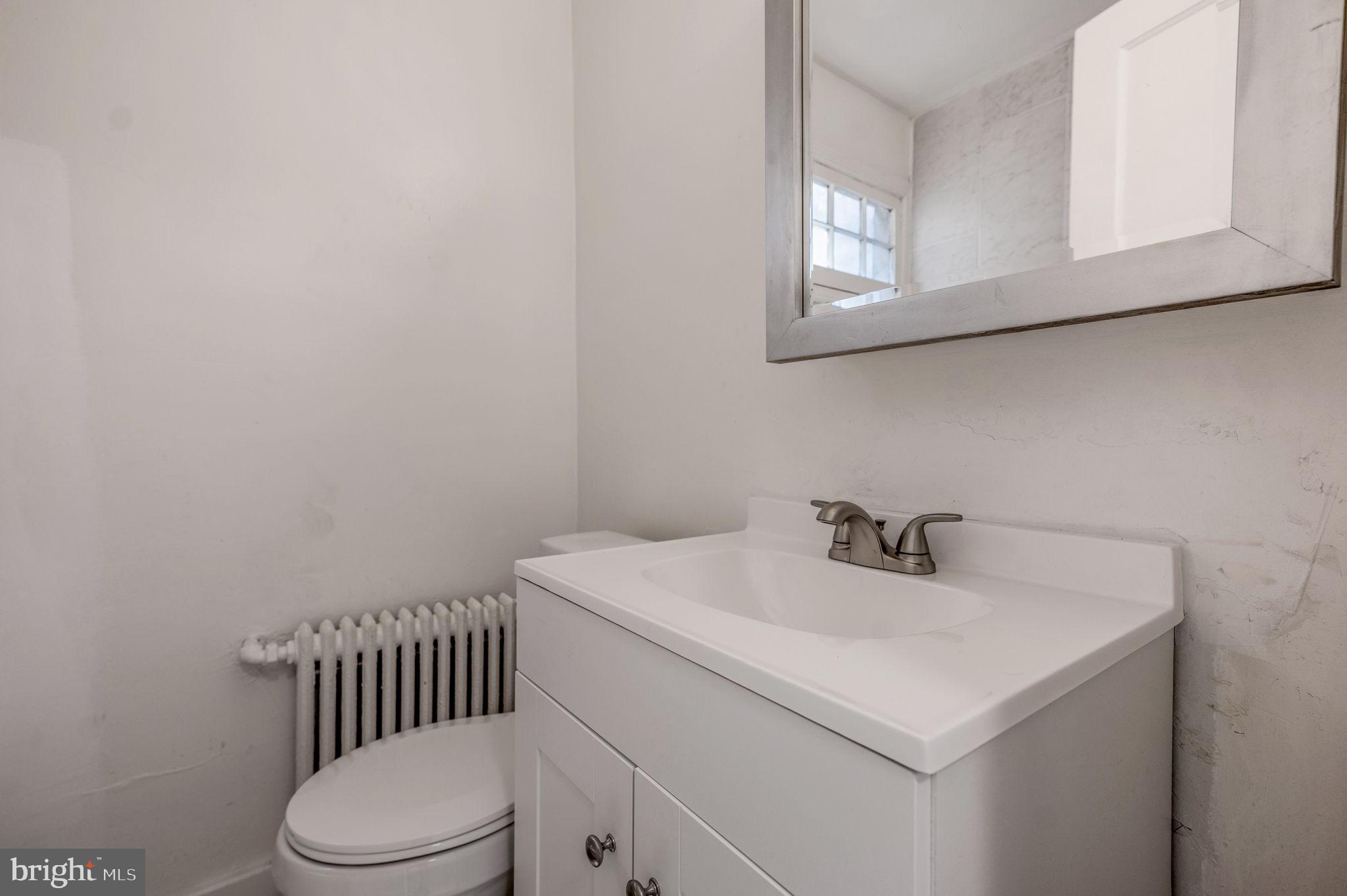 2538 9th Street Northwest, Unit B Washington, DC 20001 - Photo 14 of 19 a bathroom with a sink toilet and mirror