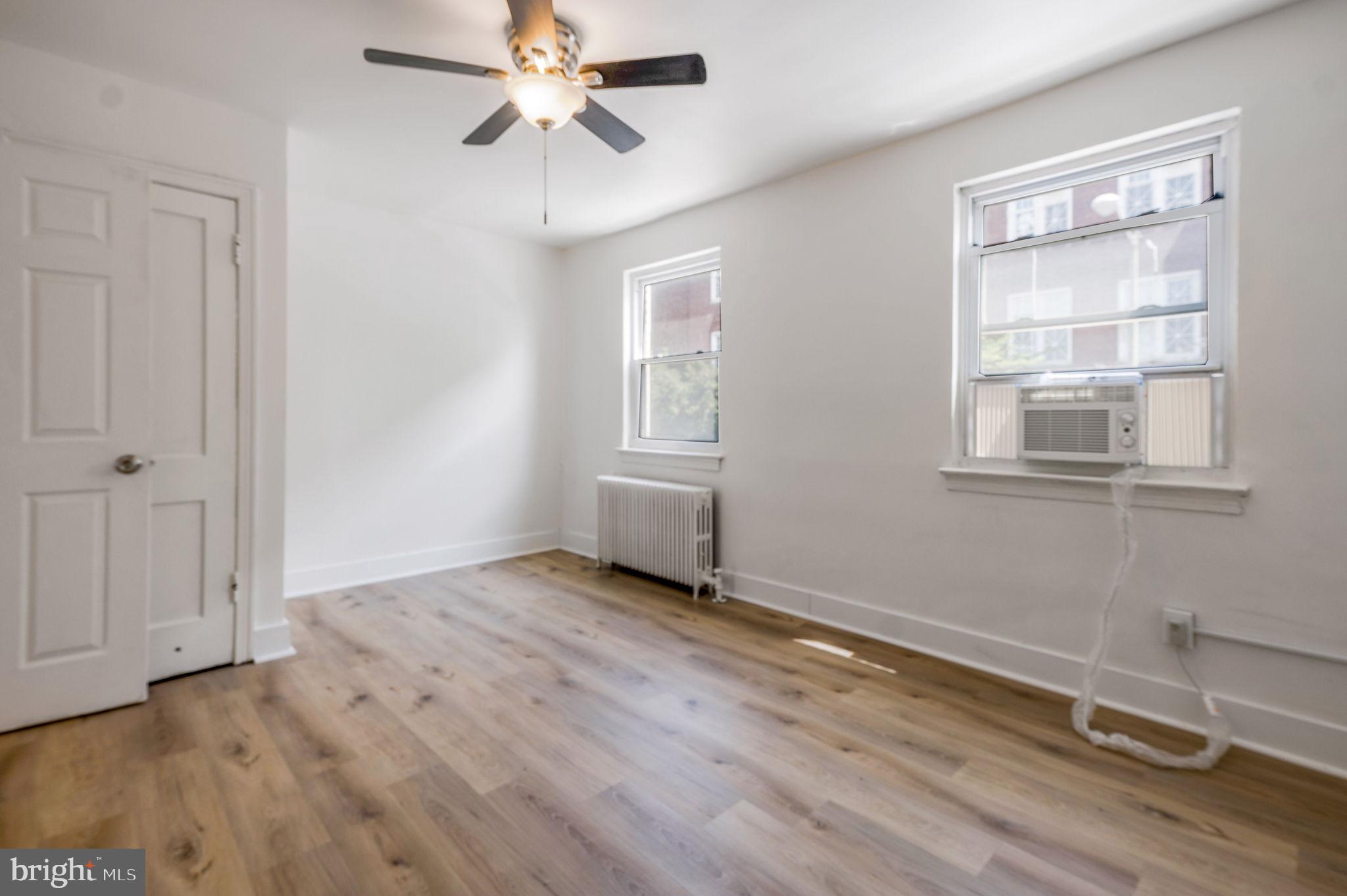 2538 9th Street Northwest, Unit B Washington, DC 20001 - Photo 8 of 19 an empty room with wooden floor closet and windows