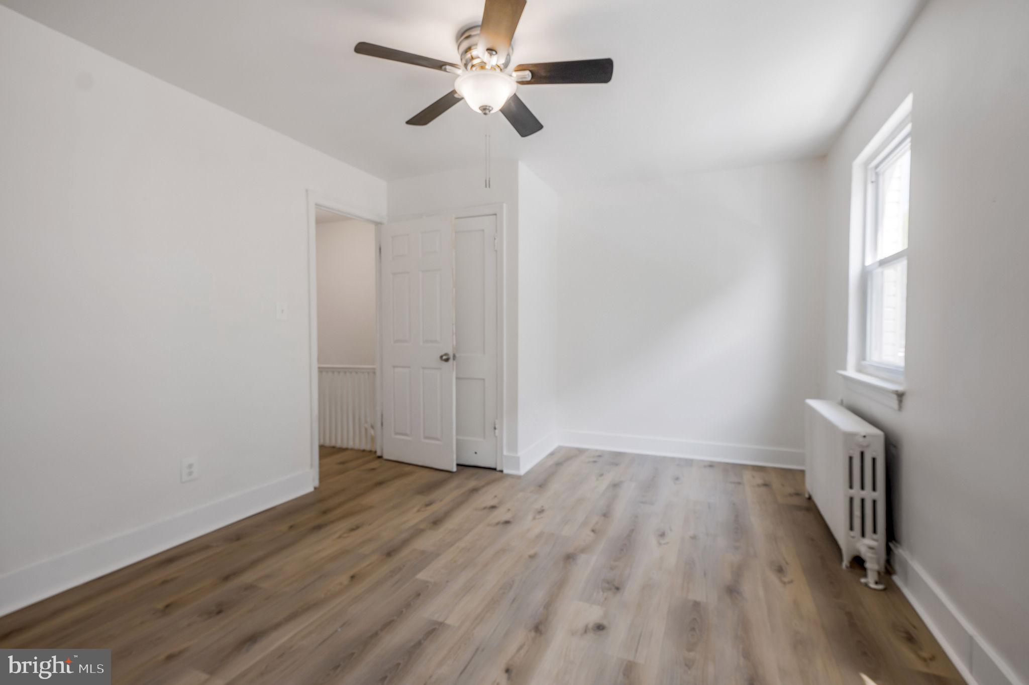2538 9th Street Northwest, Unit B Washington, DC 20001 - Photo 9 of 19 an empty room with wooden floor fan and windows