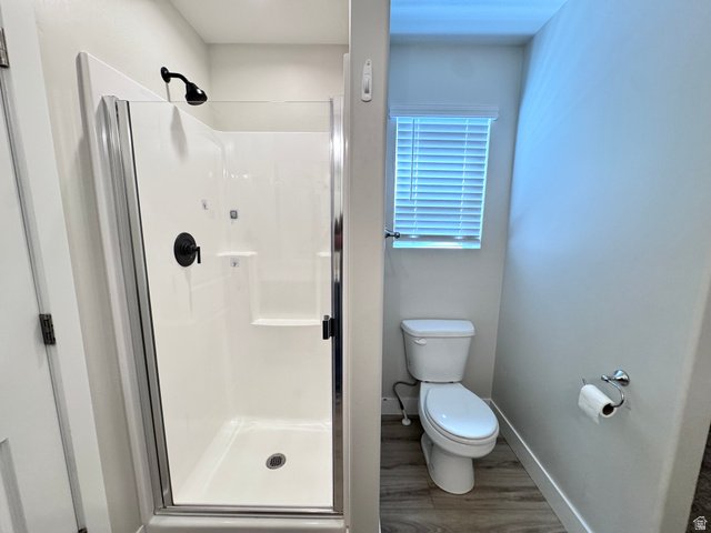 12339 Remy Road, Unit 422 Herriman, UT 84096 - Photo 22 of 36 Bathroom with a shower stall and dark wood-style flooring