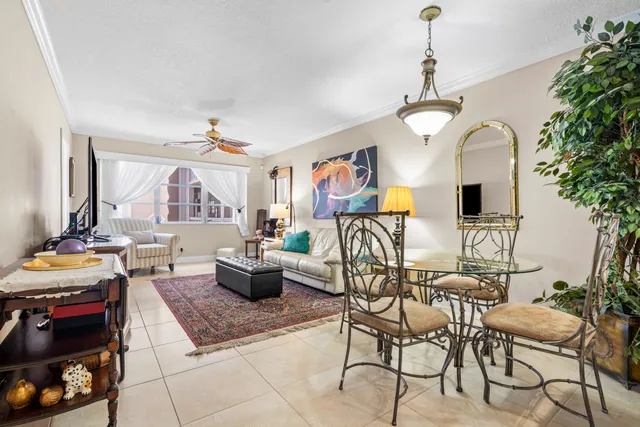 a living room with furniture a chandelier and a fireplace