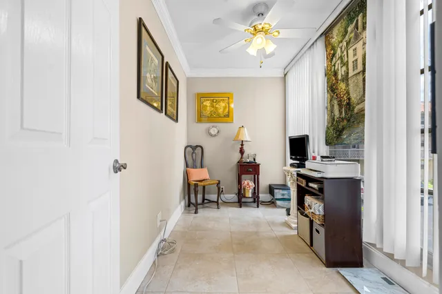a view of a hallway with workspace and windows