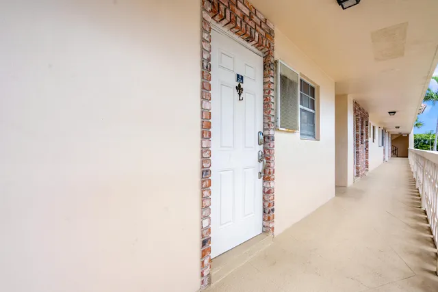 a view of a hallway with a white walls and stairs