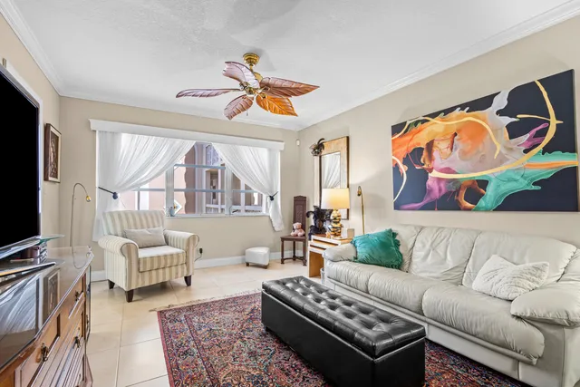 a living room with furniture a rug and a window