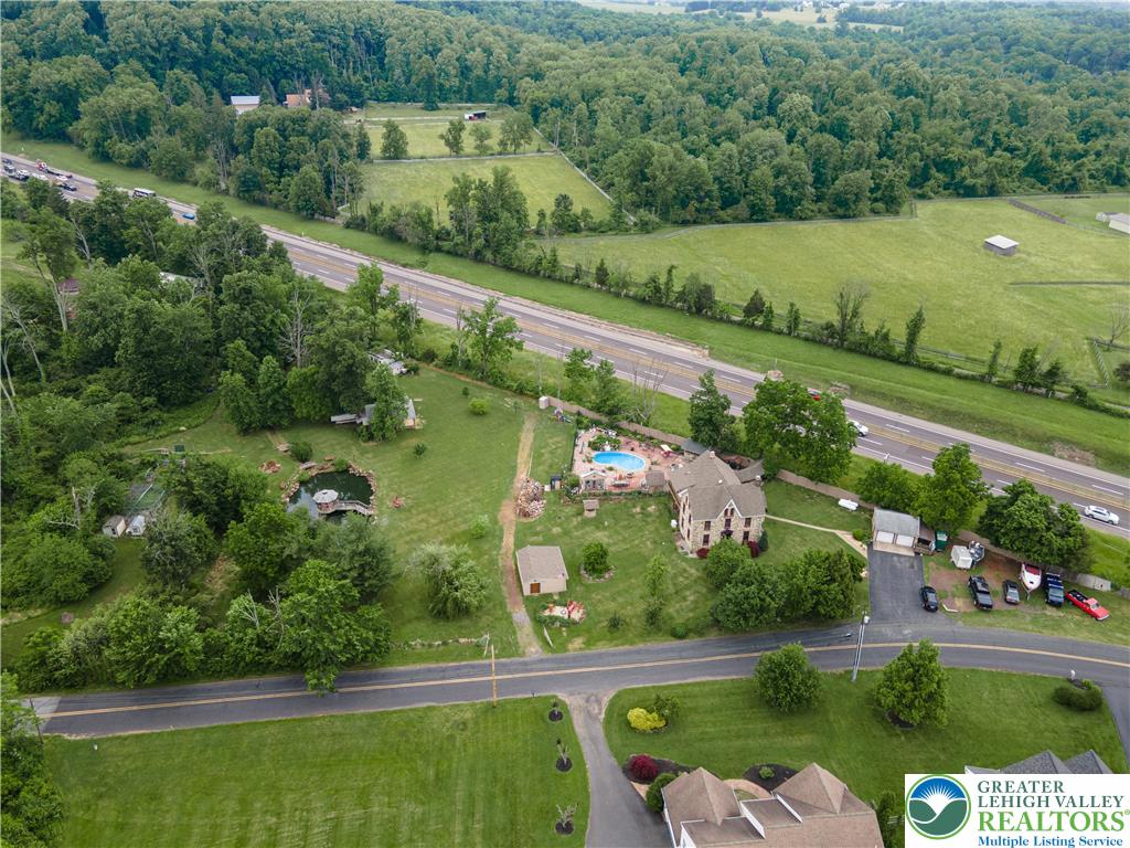 2485 Hieter Road Quakertown, PA 18951 - Photo 2 of 97 An aerial perspective reveals a private pool oasis set against a backdrop of verdant hills and open fields.