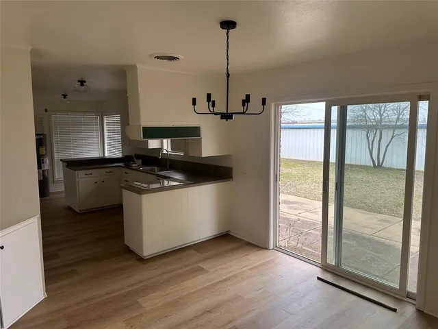 a kitchen with a refrigerator and a stove top oven