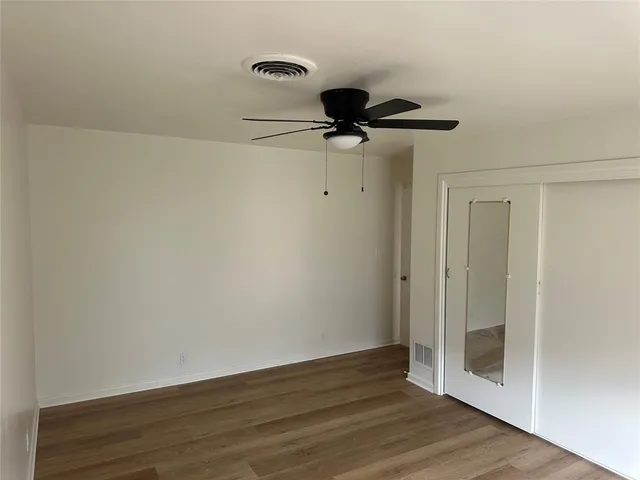 a view of a hallway with a wooden floor