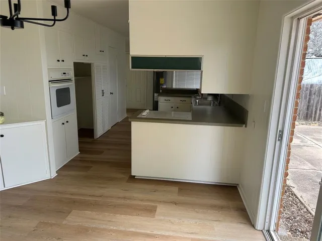 a kitchen with stainless steel appliances a refrigerator and a stove top oven