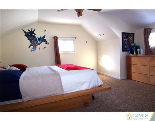 198 McFarlane Road Colonia, NJ 07067 - Photo 13 of 22 a bedroom with a bed and a painting on the wall