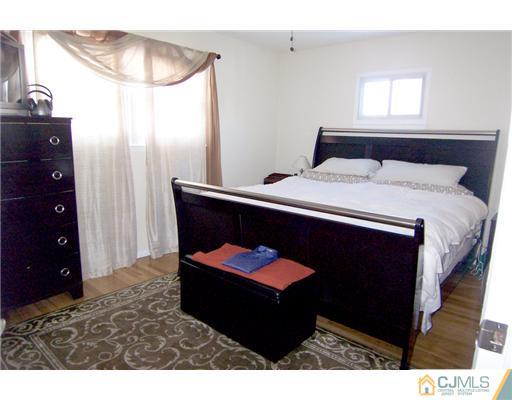 198 McFarlane Road Colonia, NJ 07067 - Photo 15 of 22 a bedroom with a bed and a chandelier