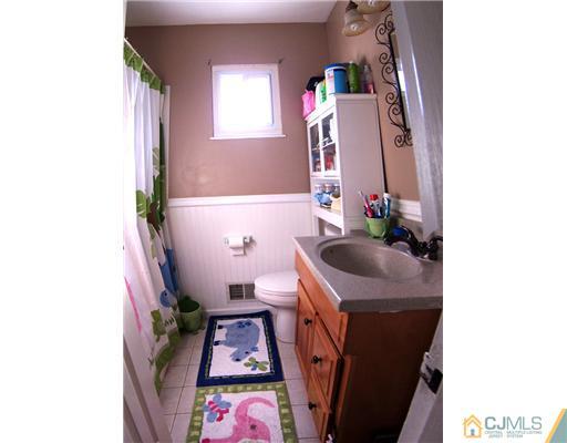 198 McFarlane Road Colonia, NJ 07067 - Photo 18 of 22 a bathroom with a sink toilet and window