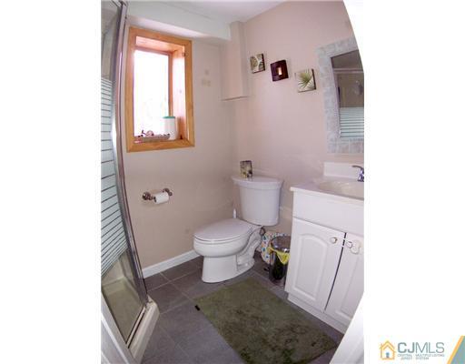 198 McFarlane Road Colonia, NJ 07067 - Photo 19 of 22 a bathroom with a toilet and a shower