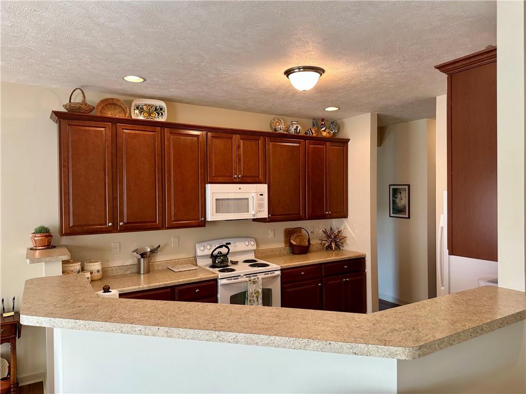 624 Setter Lane Clairton, PA 15025 - Photo 11 of 50 a kitchen with stainless steel appliances granite countertop a sink stove and refrigerator