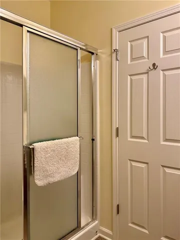 a bathroom with a shower and a glass door
