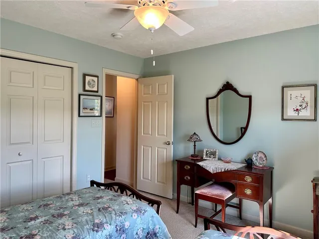 a living room with table chairs and a chandelier