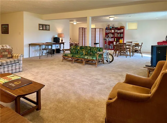 a living room with furniture a dining table and chairs